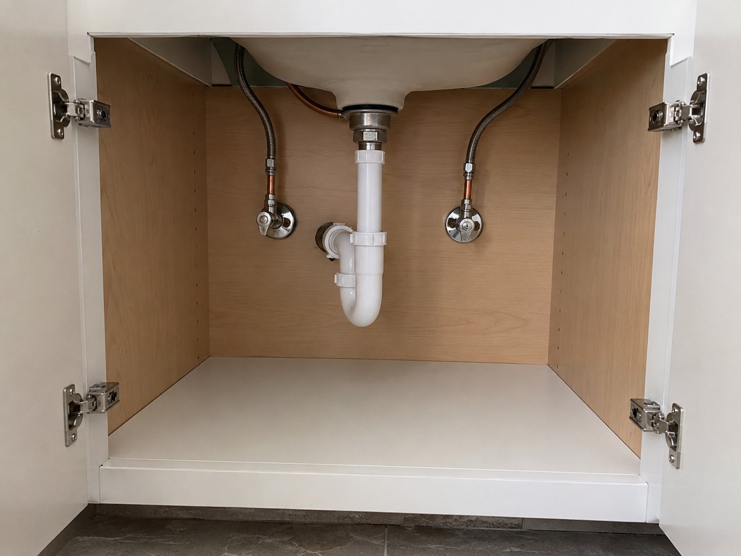 Clean under-sink plumbing leak repair example